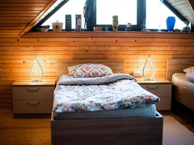 a bedroom with a bed and two lamps on two tables at Relaxing Retreat with Hot Tub in Sevnica - Three Bedroom Apartment in Sevnica