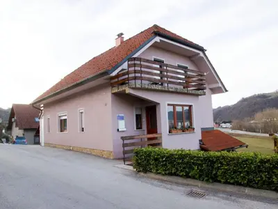 a small house with a balcony on a street at Relaxing Retreat with Hot Tub in Sevnica - Three Bedroom Apartment in Sevnica