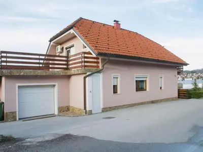 a small house with an orange roof and a garage at Relaxing Retreat with Hot Tub in Sevnica - Three Bedroom Apartment in Sevnica