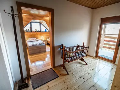 a room with a bedroom with a bed and a window at Relaxing Retreat with Hot Tub in Sevnica - Three Bedroom Apartment in Sevnica