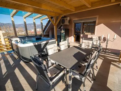 a patio with a table and chairs and a swimming pool at Relaxing Retreat with Hot Tub in Sevnica - Three Bedroom Apartment in Sevnica