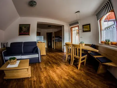 a living room with a couch and a table at Riverside Pines Luce Apartments with Balcony - Two Bedroom Apartment with Balcony in Luče