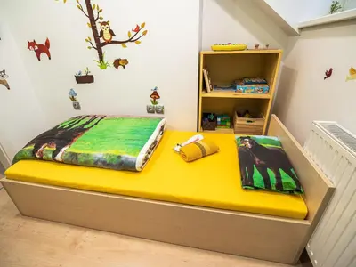 a bed in a childs bedroom with a yellow mattress at Elegant and Stylish Retreat Apartments with Terrace - Three Bedroom Apartment with Terrace in Brežice