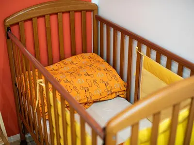 a crib with a pillow in a room at Elegant and Stylish Retreat Apartments with Terrace - Three Bedroom Apartment with Terrace in Brežice