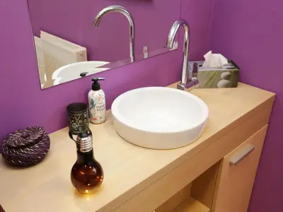 a bathroom with a sink and a bottle on a counter at Elegant and Stylish Retreat Apartments with Terrace - Three Bedroom Apartment with Terrace in Brežice