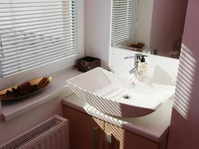 a bathroom with a white sink and a window at Elegant and Stylish Retreat Apartments with Terrace - Three Bedroom Apartment with Terrace in Brežice