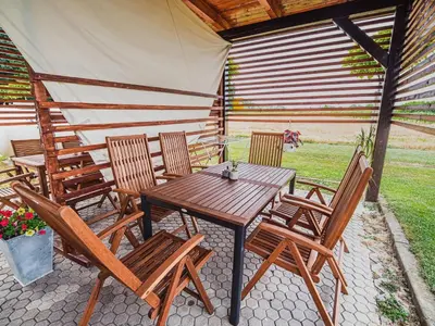 a wooden table and chairs on a patio at Elegant and Stylish Retreat Apartments with Terrace - Three Bedroom Apartment with Terrace in Brežice