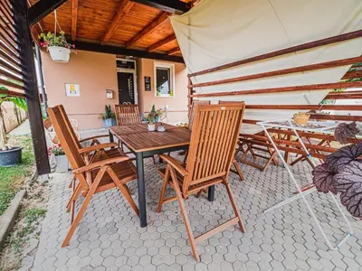 a table and chairs on a patio with an umbrella at Elegant and Stylish Retreat Apartments with Terrace - Three Bedroom Apartment with Terrace in Brežice