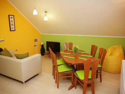 a dining room with a table and chairs and a couch at Elegant and Stylish Retreat Apartments with Terrace - Three Bedroom Apartment with Terrace in Brežice