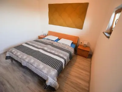 a small bedroom with a bed and two night stands at Relax and Rustic Apartments with Terrace - Standard One Bedroom Apartment with Terrace in Brežice