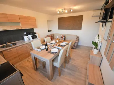 a kitchen and dining room with a table and chairs at Relax and Rustic Apartments with Terrace - Standard One Bedroom Apartment with Terrace in Brežice