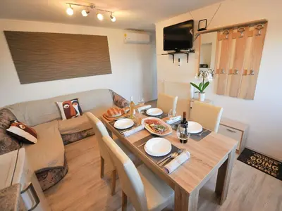 a living room with a table and a couch at Relax and Rustic Apartments with Terrace - Standard One Bedroom Apartment with Terrace in Brežice