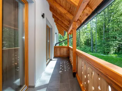 a porch of a house with a large window at The Woodland Nook Apartments Bohinj - One Bedroom Apartment with Balcony in Bohinj