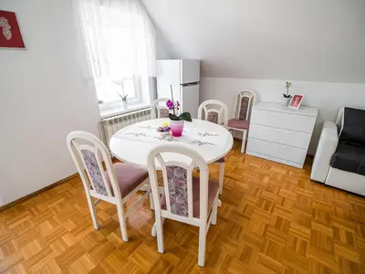 a dining room table and chairs in a room at Mountain View Haven Apartments - One Bedroom Apartment with Balcony in Bovec