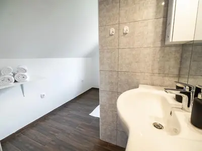 a bathroom with a sink and a toilet at Mountain View Haven Apartments - One Bedroom Apartment with Balcony in Bovec