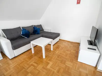 a living room with a couch and a table at Mountain View Haven Apartments - One Bedroom Apartment with Balcony in Bovec