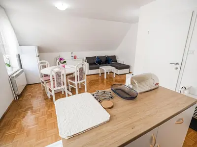 a kitchen and living room with a table and chairs at Mountain View Haven Apartments - One Bedroom Apartment with Balcony in Bovec