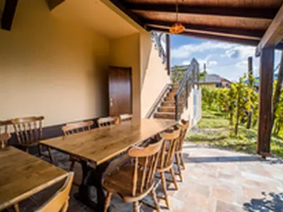 a dining room with a wooden table and chairs at Serene Hollow Holiday Home with Mountain View - Two Bedroom Holiday Home with Mountain View in Cerklje ob Krki