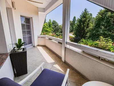 an empty balcony with a view of a garden at Stunning Rural Holiday Home with Garden and BBQ - Four Bedroom Holiday Home in Brežice