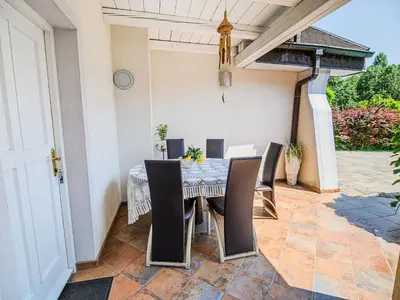 a patio with a table and chairs on a patio at Stunning Rural Holiday Home with Garden and BBQ - Four Bedroom Holiday Home in Brežice