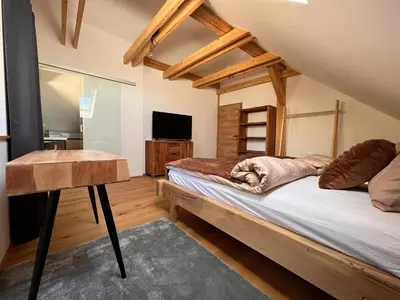 a bedroom with a bed and a desk and a television at Mountain View Villa with Sauna and Hot-Tub - Three Bedroom Villa with Sauna and Hot-Tub in Slovenj Gradec