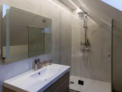 a white bathroom with a sink and a shower at Mountain View Villa with Sauna and Hot-Tub - Three Bedroom Villa with Sauna and Hot-Tub in Slovenj Gradec