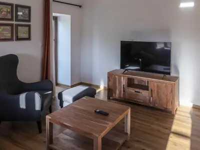 a living room with a flat screen tv and a coffee table at Mountain View Villa with Sauna and Hot-Tub - Three Bedroom Villa with Sauna and Hot-Tub in Slovenj Gradec