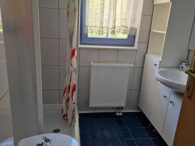 a bathroom with a toilet and a sink and a window at Bovec Comfortable Apartment with Mountain View - One Bedroom Apartment with Mountain View in Bovec