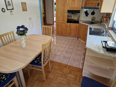 a kitchen with a table with a vase of flowers on it at Bovec Comfortable Apartment with Mountain View - One Bedroom Apartment with Mountain View in Bovec
