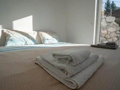 a bedroom with a bed with towels on it at Three Bedroom Holiday Home with Terrace and Sauna in Tolmin