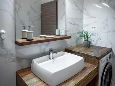 a bathroom with a sink and a washing machine at Three Bedroom Holiday Home with Terrace and Sauna in Tolmin