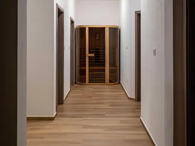 an empty corridor with wooden floors in a building at Three Bedroom Holiday Home with Terrace and Sauna in Tolmin