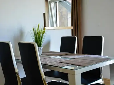 a dining room table with four chairs around it at One Bedroom Apartment in Brežice