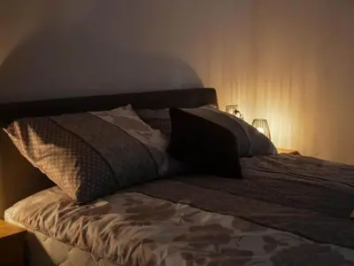 a bed with three pillows on top of it at One Bedroom Apartment in Brežice