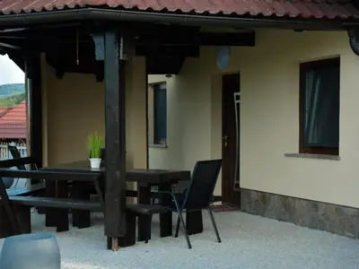 a patio with a table and chairs under a roof at One Bedroom Apartment in Brežice
