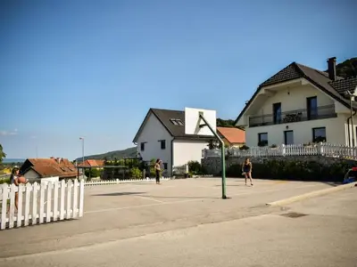 a group of people playing a game of basketball on a court at One Bedroom Apartment in Brežice
