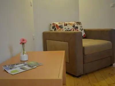 a living room with a couch and a coffee table at One Bedroom Apartment in Brežice