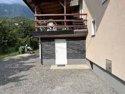 a building with a balcony with cows sitting on it at Meadow Tranquil Apartments with Evergreen Garden - Studio Apartment in Žirovnica