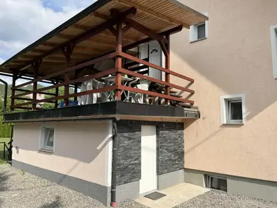 a balcony on the side of a building at Meadow Tranquil Apartments with Evergreen Garden - Studio Apartment in Žirovnica