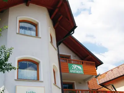 a building with a balcony on the side of it at Riverside Pines Luce Apartments with Balcony - One Bedroom Apartment with Balcony in Luče