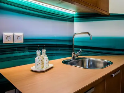 a kitchen counter with a sink and two bottles at Riverside Pines Luce Apartments with Balcony - One Bedroom Apartment with Balcony in Luče