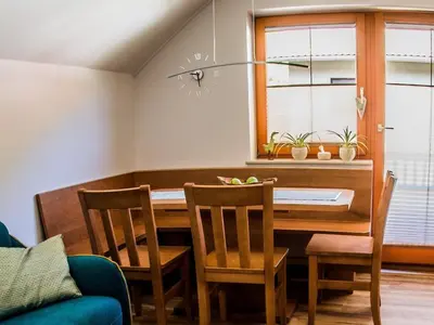 a dining room with a table and chairs at Riverside Pines Luce Apartments with Balcony - One Bedroom Apartment with Balcony in Luče