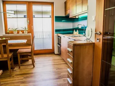 a kitchen with a table and a dining room at Riverside Pines Luce Apartments with Balcony - One Bedroom Apartment with Balcony in Luče