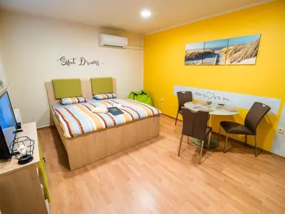 a bedroom with a bed and a table and chairs at Elegant and Stylish Retreat Apartments with Terrace - Studio Apartment with Terrace in Brežice