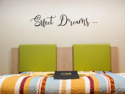 two beds with a sign that reads sit dreams at Elegant and Stylish Retreat Apartments with Terrace - Studio Apartment with Terrace in Brežice