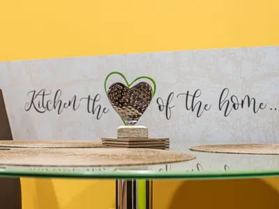 a table with a heart vase with a sign that reads behind the home at Elegant and Stylish Retreat Apartments with Terrace - Studio Apartment with Terrace in Brežice