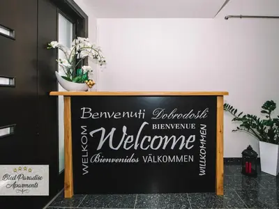 a chalkboard sign in a room with a welcome sign at Bled Prestigious and Stylish Apartments - Classic One Bedroom Apartment with Balcony in Bled