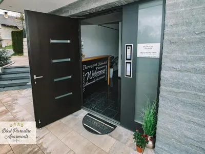 a door to a restaurant with a sign on it at Bled Prestigious and Stylish Apartments - Classic One Bedroom Apartment with Balcony in Bled