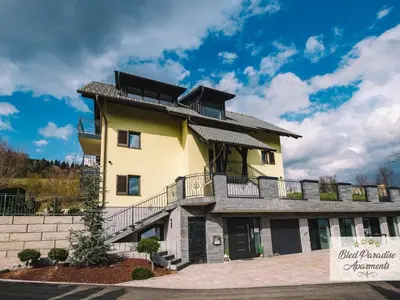a large yellow building with a balcony at Bled Prestigious and Stylish Apartments - Classic One Bedroom Apartment with Balcony in Bled
