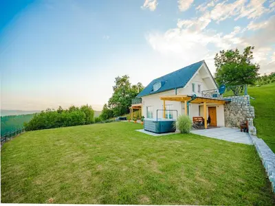 a house on top of a hill with a yard at Secluded Escape Hilltop Villa with Hot-Tub - Two Bedroom Villa with Hot-Tub